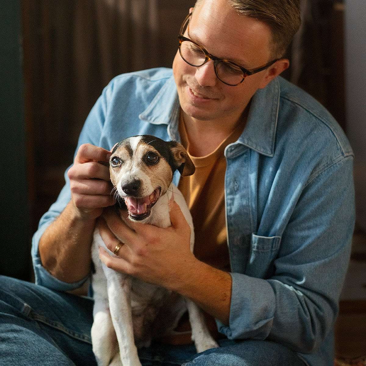 Dog cuddling with human